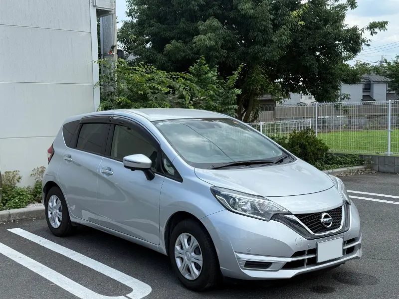 a car parked in a parking lot 日産ノート（2019年式）の写真